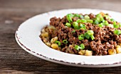 Seared minced meat with potatoes and spring onions