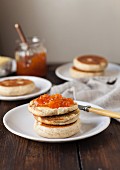 A toasted English muffin spread with jam