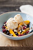 Vanilla ice cream on exotic fruit salad with coconut chips