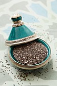 Chia seeds in a turquoise dish with silver edges