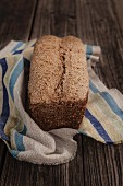 Homemade wholegrain rye bread on a rustic wooden table