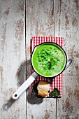 Pea soup with mint in an enamel saucepan (seen from above)