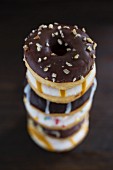 A stack of doughnuts with different glazes
