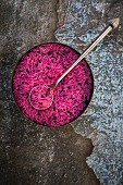 Pinkfarbener ungekochter Bio-Basmatireis in Schüssel (Aufsicht)