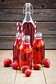 Bottles of homemade strawberry lemonade