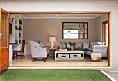 Comfortable living room with upholstered furniture and white fitted shelving