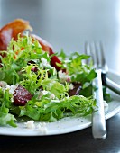 A mixed leaf salad with beetroot and ham