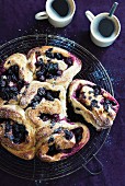 Blueberry pastries with icing sugar served with coffee