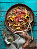 Freekah salad with tomatoes and pansies