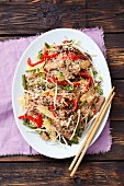 Noodle salad with fried pork, bamboo shoots, peppers, mushrooms, beans and sesame seeds (China)