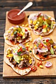 Homemade tortillas with pork, avocado, sweetcorn, red onions and chilli peppers