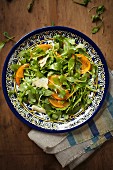 Rocket salad with persimmon and Parmesan cheese
