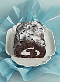 Chocolate Swiss roll dusted with icing sugar