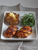 Spicy devil's chicken with a baked potatoes