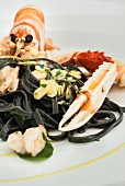 Squid pasta and a langoustine with almonds, Restaurant Bacino Grande in Porto Cesareo, Italy