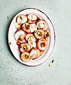 Roasted nectarine slices with vanilla yoghurt and pistachio nuts (seen from above)