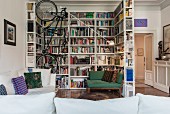 Industrial-style bookcase used as partition around reading corner with vertical bike-rack