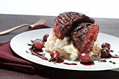 Beefsteak on mashed potatoes with red wine onions