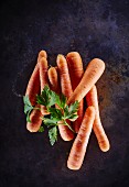 Fresh carrots with parsley on a metal surface