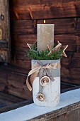 Pillar candle in stone-effect vase as Advent gift