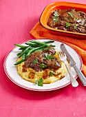 Beef cheeks braised in red wine on polenta with green beans