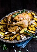 Roast chicken with garlic, potatoes and rosemary