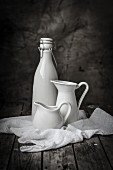 White jugs and a flip-top bottle on a muslin cloth