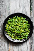 Pumpkin seeds in addition on a wooden surface