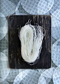Rice noodles on a wooden board