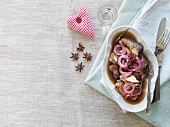 Fried herring in a spicy beer marinade with red onions