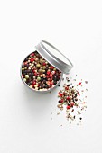 A tin of colourful peppercorns
