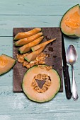 Slices of cantaloupe melon on a wooden board