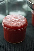 A freshly filled jar of strawberry jam