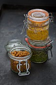 Red, yellow and green curry paste in flip-top jars