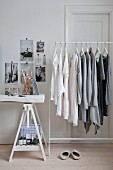 Clothing arranged by colour hung from clothes rack
