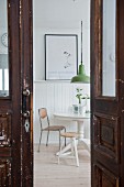 View of round table seen through old panelled door