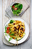 Chicken skewers with grilled vegetables and salad