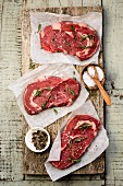 Raw beef steaks with spices