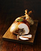 Roast turkey, sliced, on a chopping board