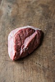 Fresh lamb spleen on a wooden board