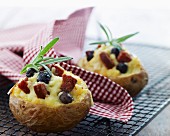 Oven-roasted potatoes with cheese, olives and salami