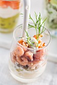 Shrimps on white asparagus in a glass