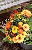 Autumnal bouquet of ornamental squashes, roses, physalis, gerbera daisies and red berries