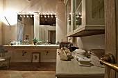 Spacious bathroom; illuminated washstand with twin sinks and two mirrors