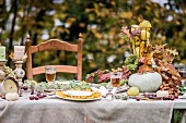 Festively set table in autumnal garden