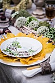 Autumnal arrangement of natural decorations on set table