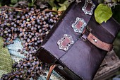 Purple leather bag on berries