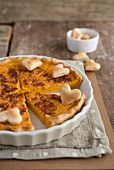 A rustic pumpkin tart decorated with pastry hearts