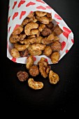 Roasted nuts in a paper bag printed with hearts