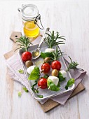 Tomato and mozzarella skewers with rosemary and basil